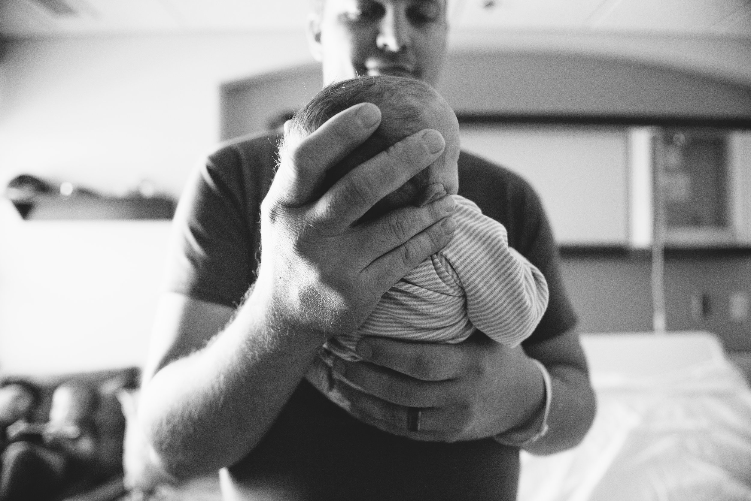 newborn in dads hands