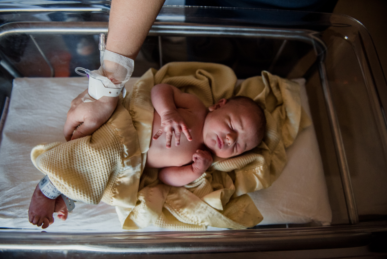 newborn with yellow blanket