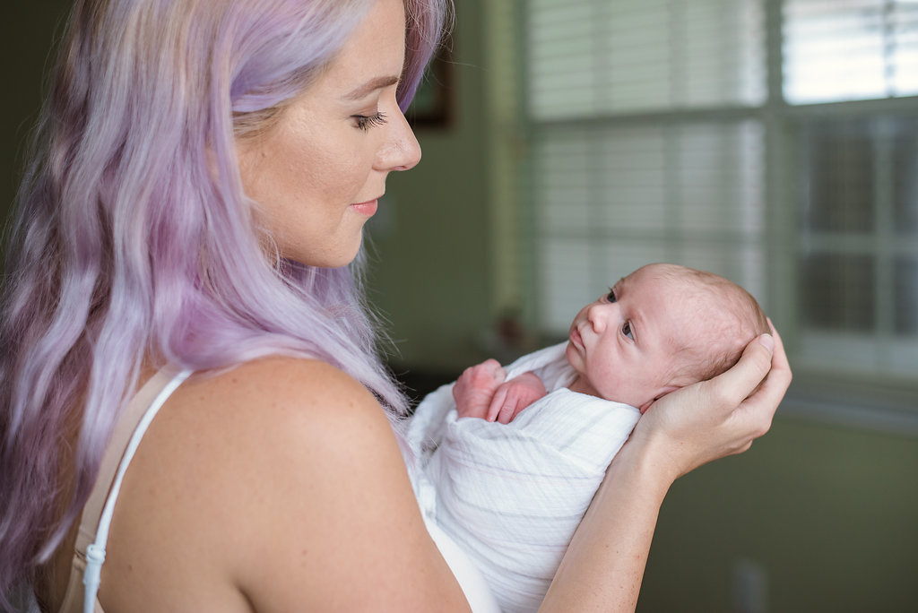 mom cradling newborn-pensacola newborn photographer