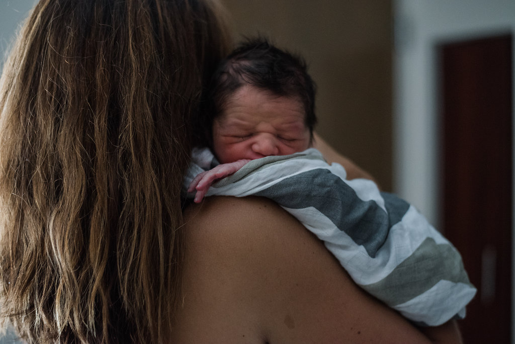 mom holding baby-pensacola Newborn photographer