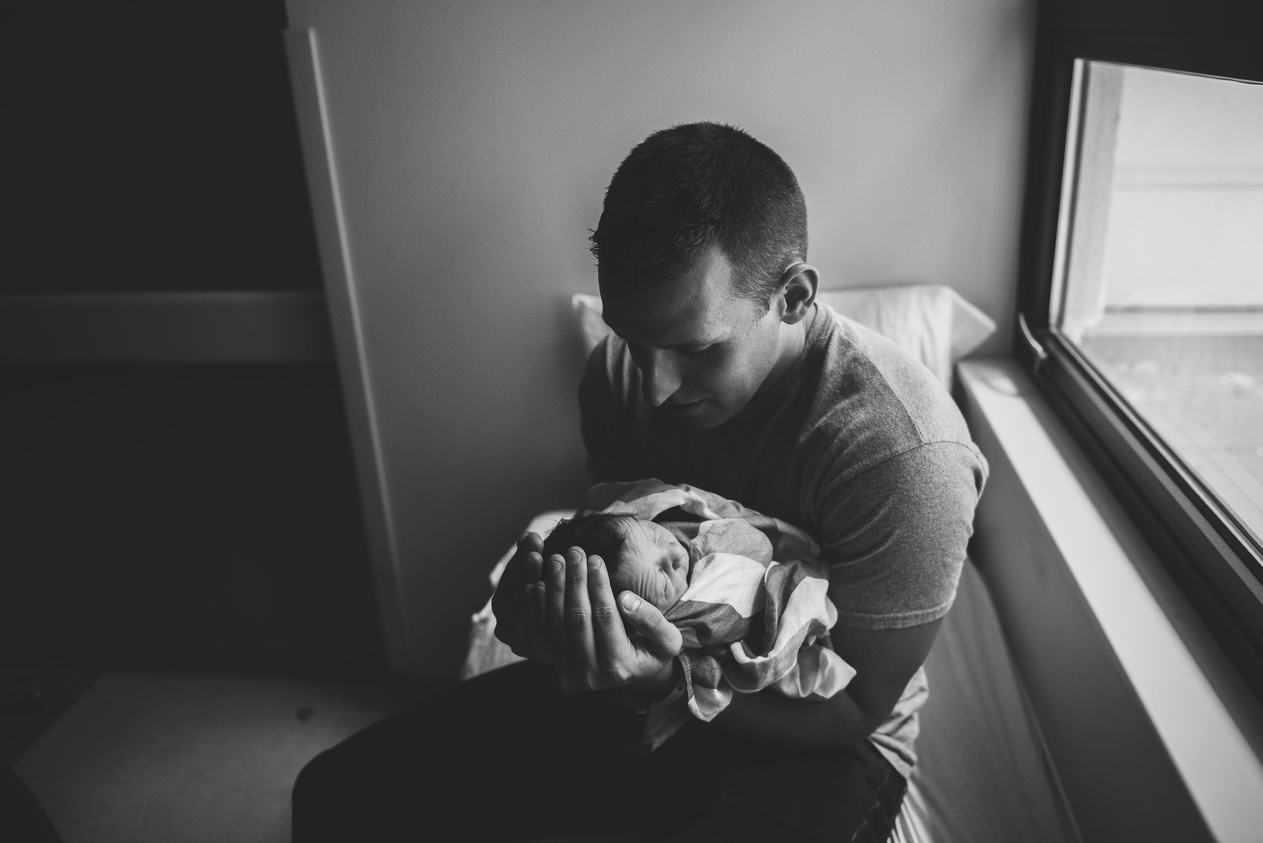 dad holding baby in arms- Pensacola Newborn Photographer