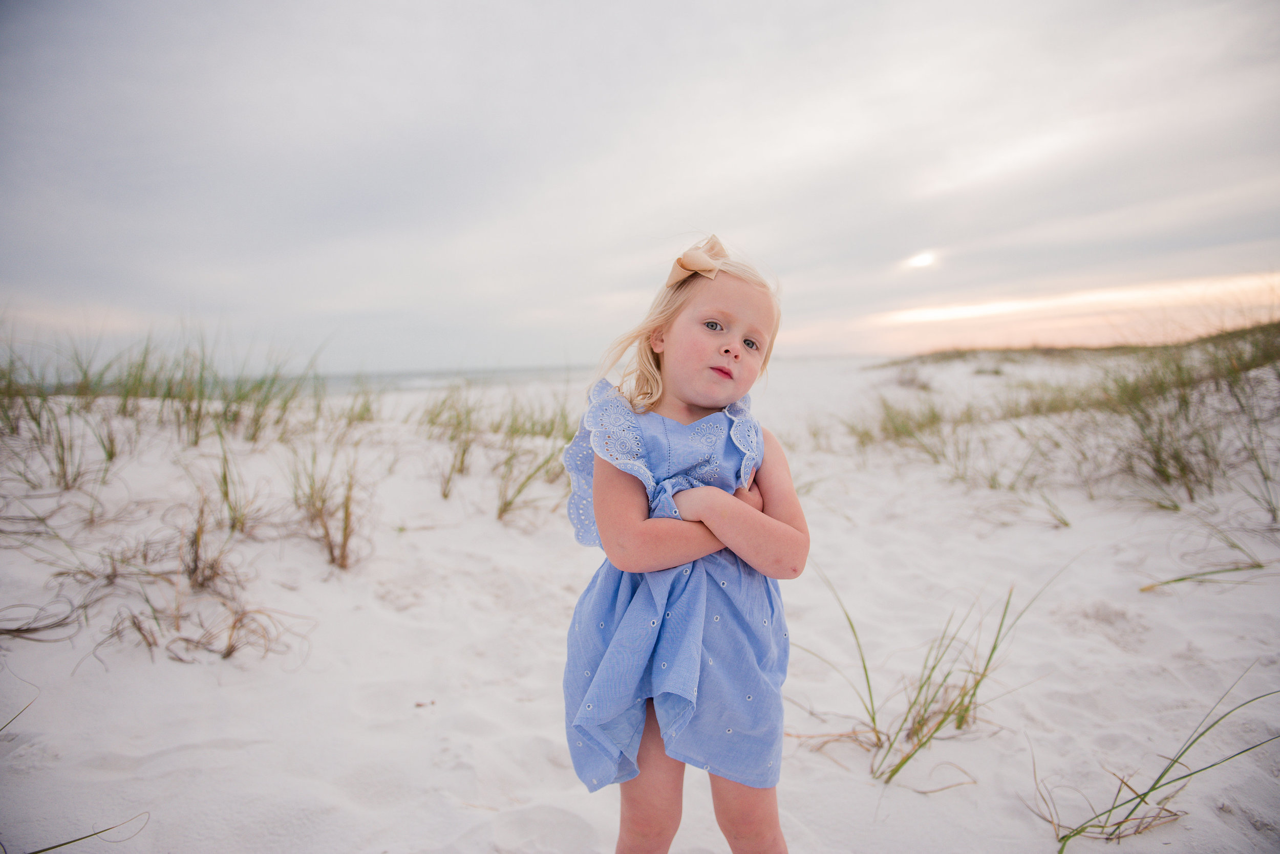 girl at beach with hands crossed-Pensacola Beach Family Photographer