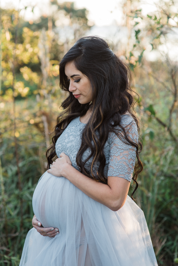 woman looking down at baby in belly-maternity photographer