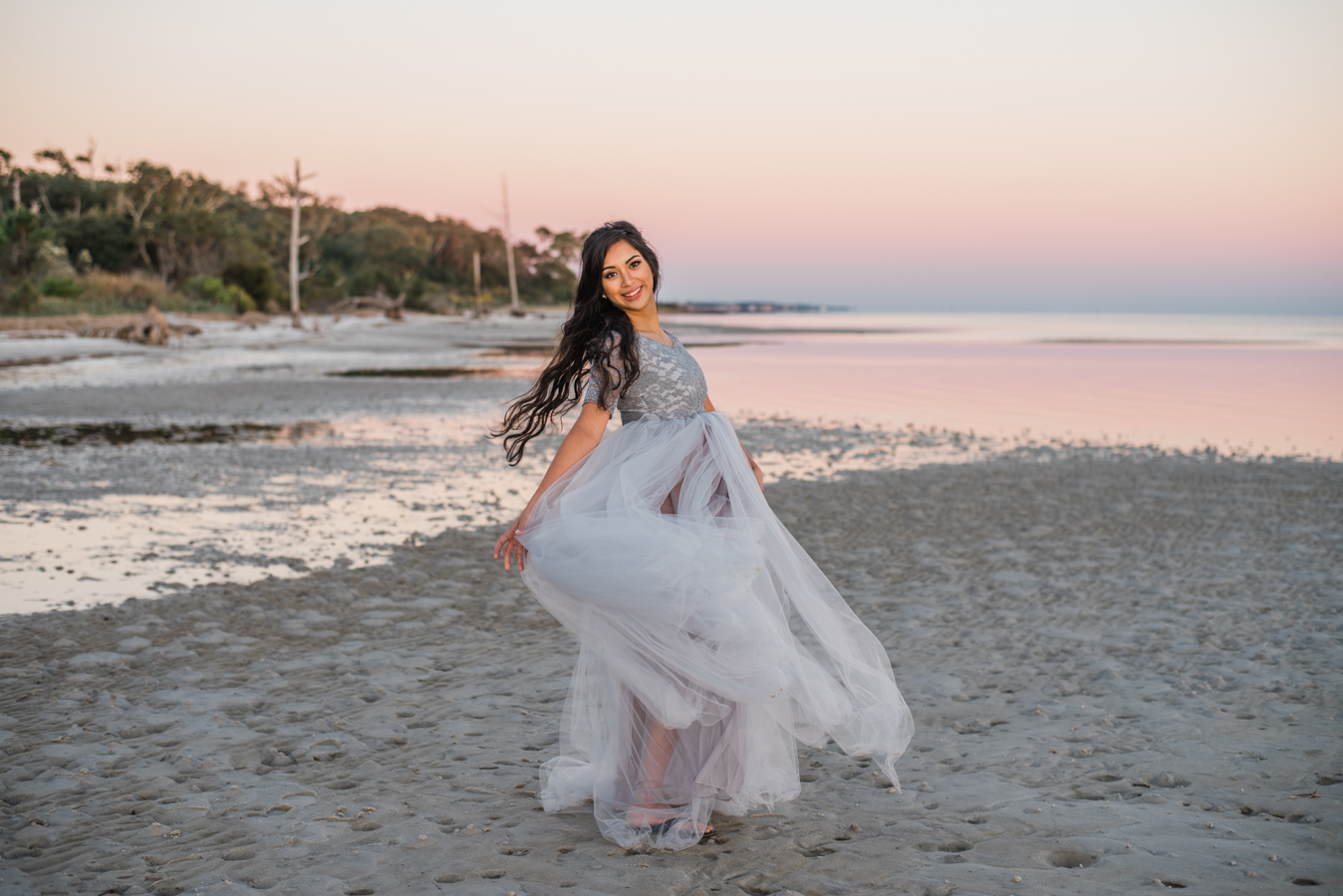lady twirling by ocean-pensacola maternity photographer