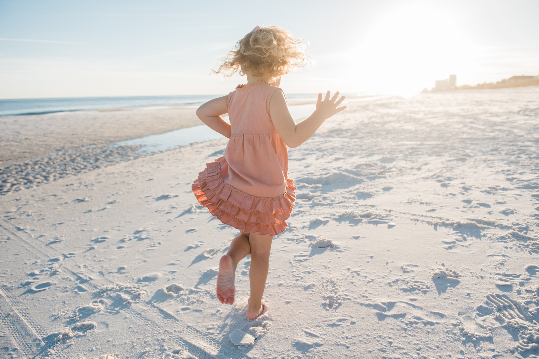 girl twirling at beach-pensacola family photographer