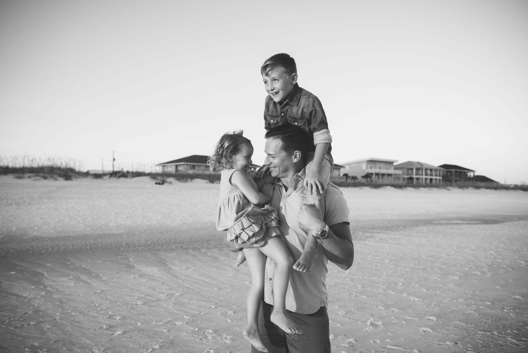 kids on dads shoulder at beach-pensacola beach family photographer