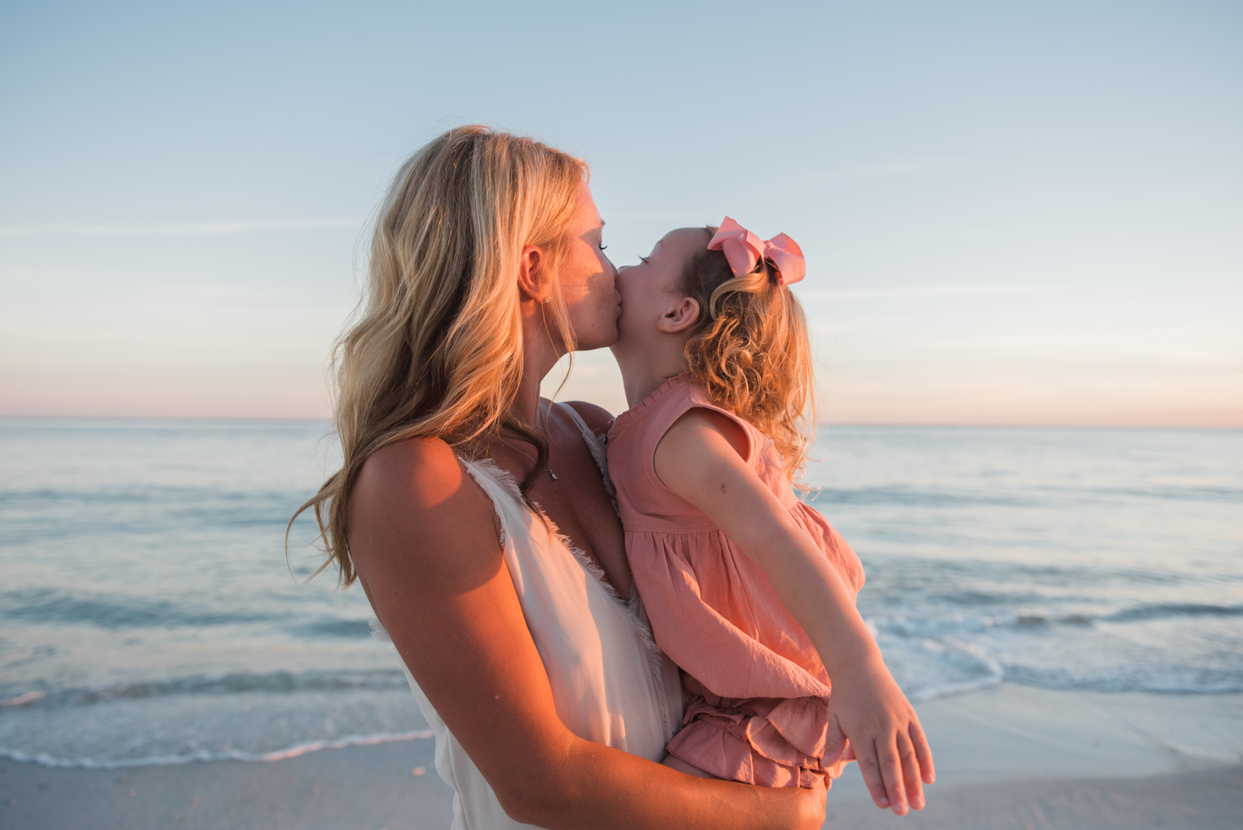 daughter kissing mom at beach-pensacola family photographer
