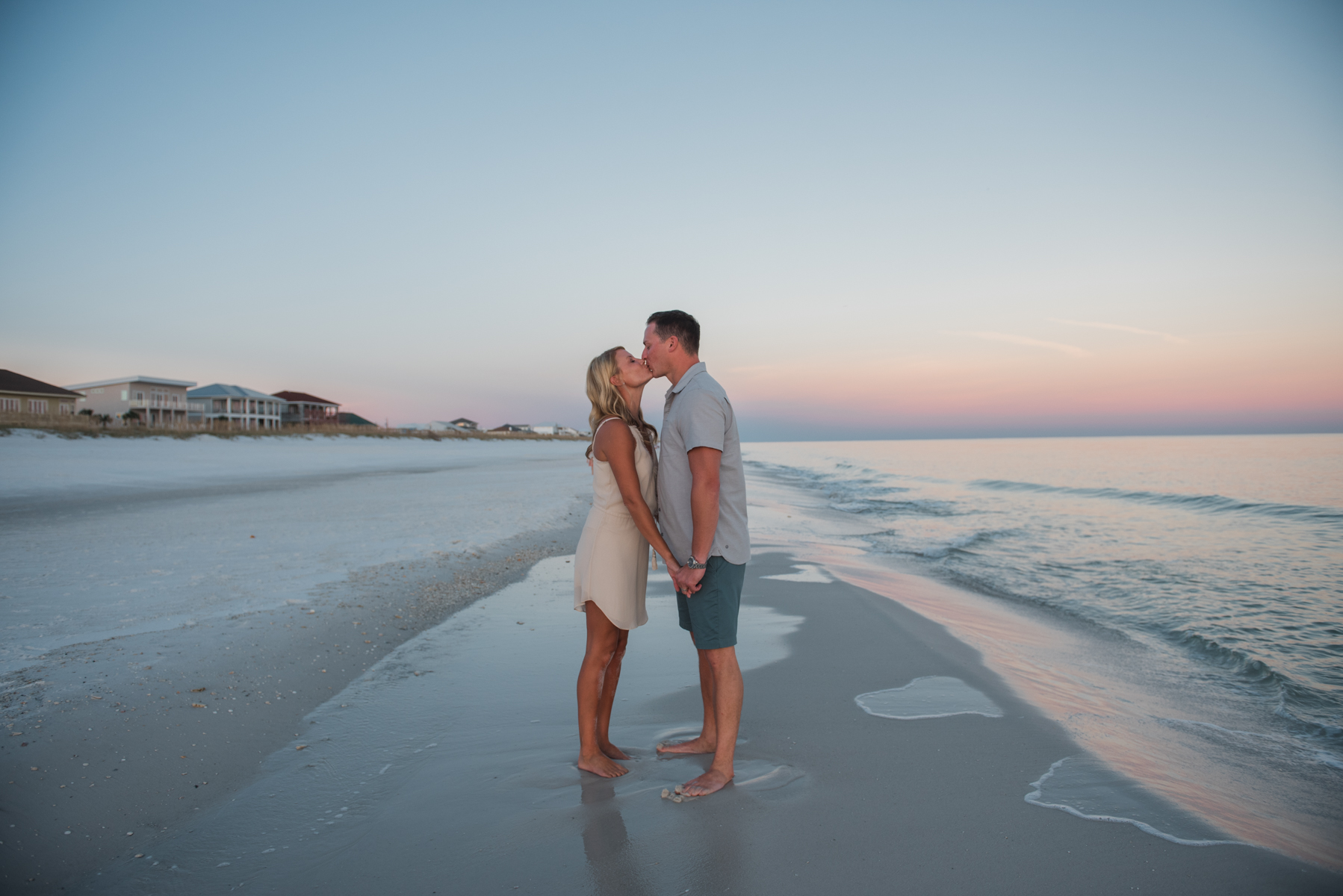 couple kissing at beach- pensacola family photographer