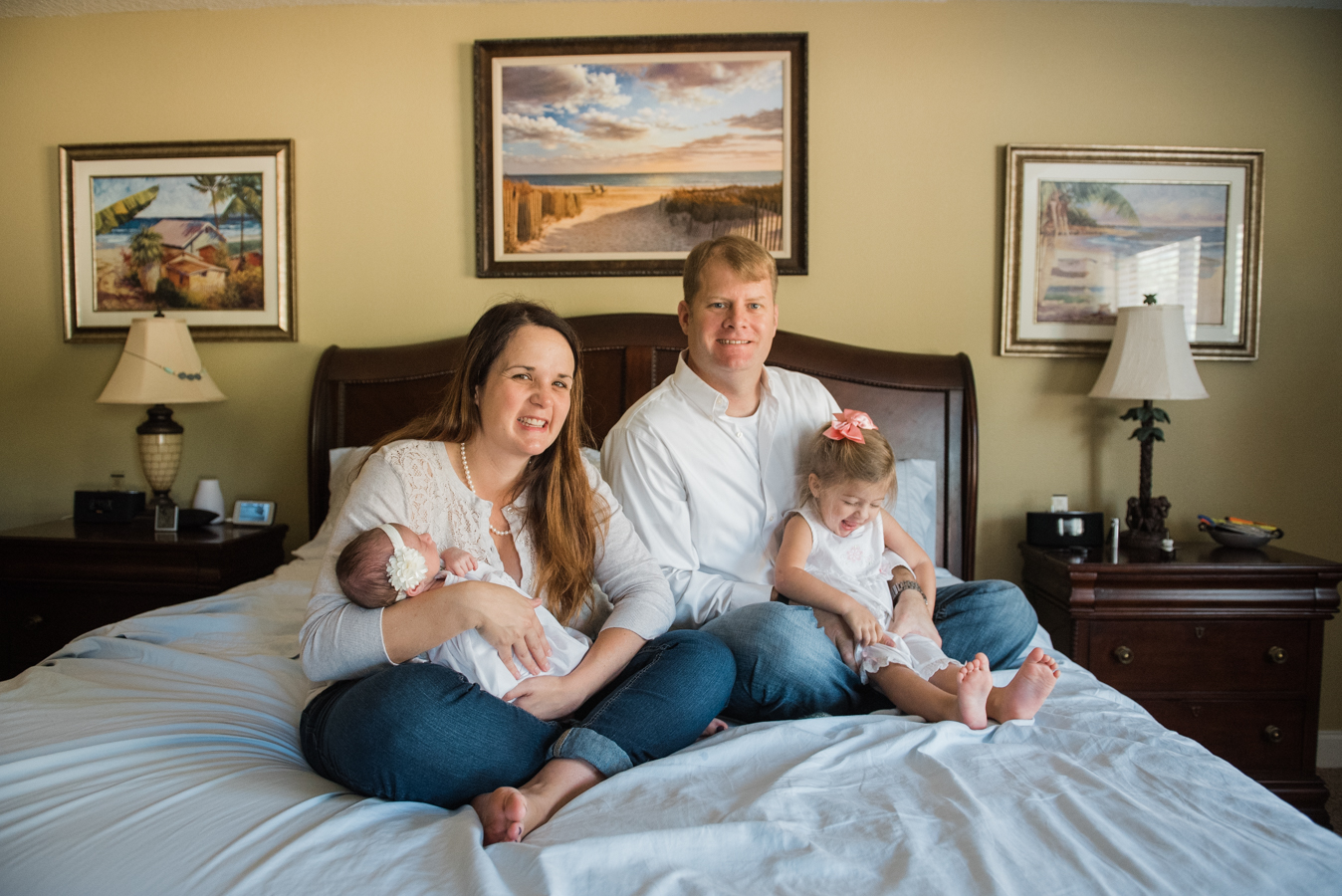 family with newborn on bed-Pensacola Baby Photographer