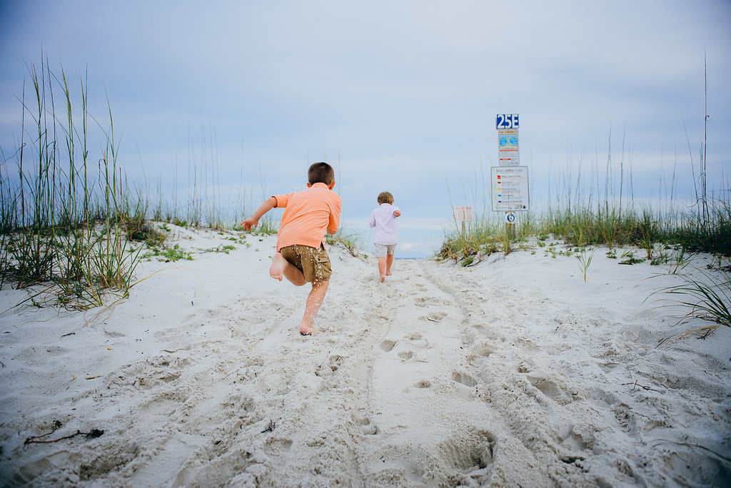 kids running in sand-Pensacola Beach Family Photographer