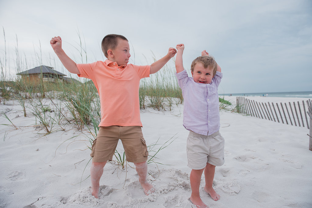 kids jumping in sand-Pensacola Beach Family Photographer