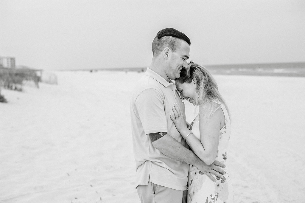 Couple embracing at beach-Pensacola Beach Family Photographer