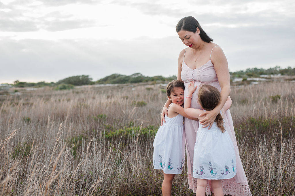 mom hugging girls-Pensacola Beach family photographer