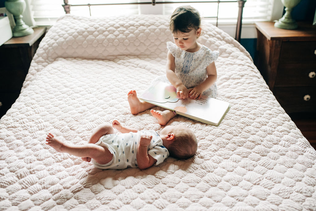 sister reading to baby-pensacola newborn photographer