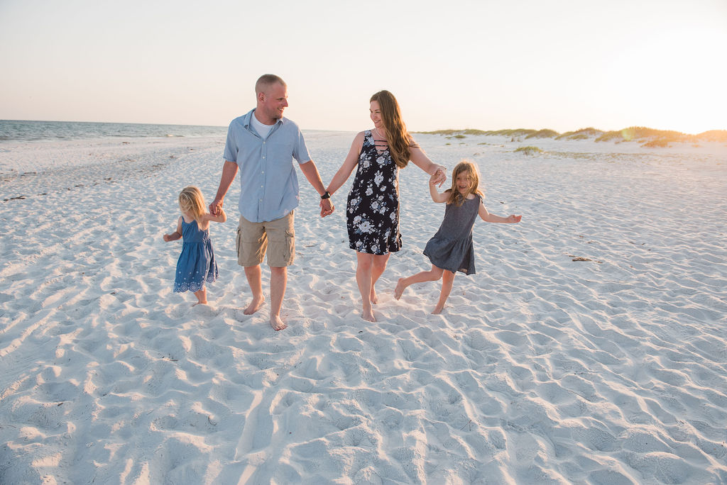family holding hands by beach-pensacola beach photographer