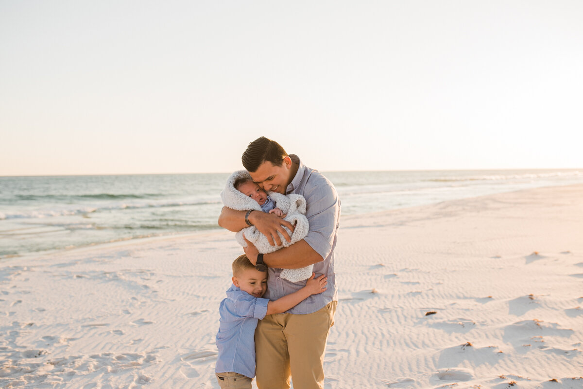 dad hugging boys on beach-pensacola beach photographer-Ann Mangum Photography