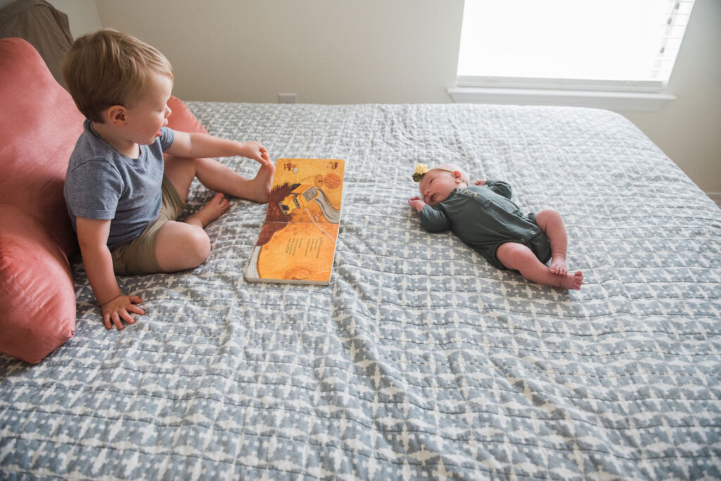 toddler reading to baby=pensacola newborn photographer-Ann Mangum Photography