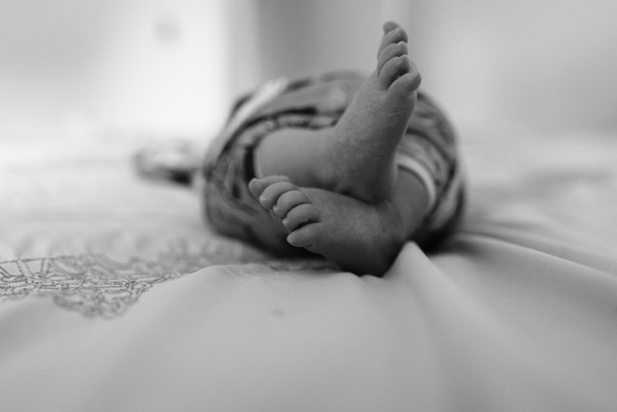 baby feet on bed-pensacola newborn photographer