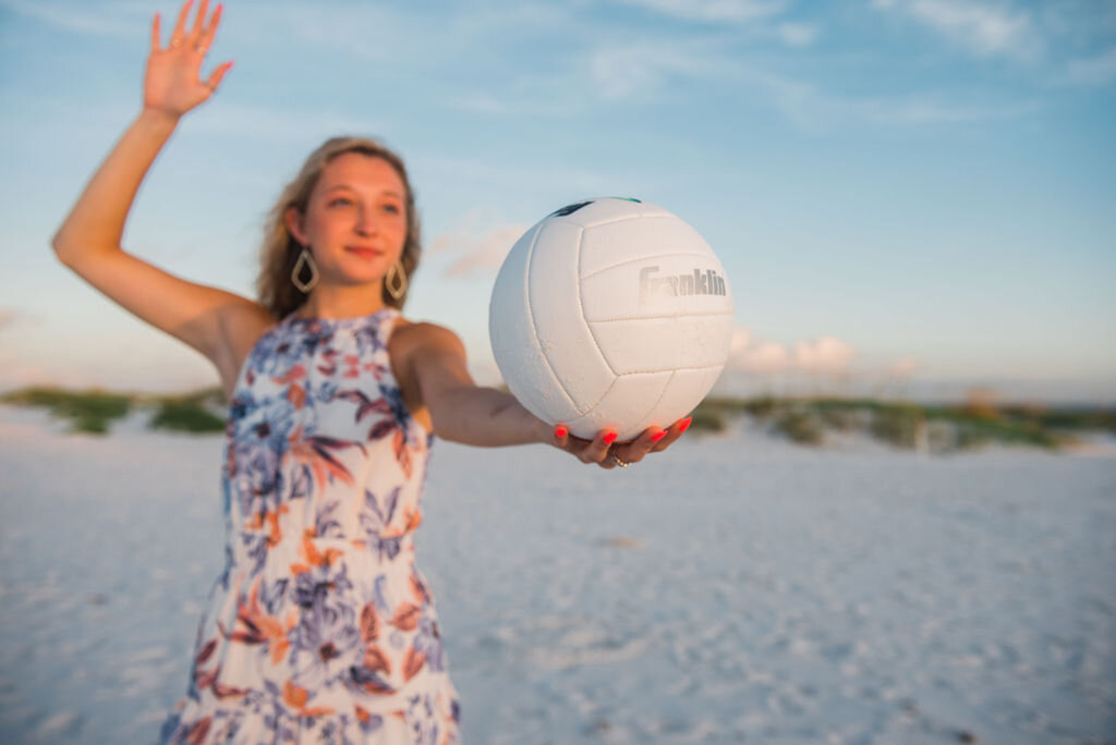volleyball held by girl at beach-pensacola beach family photographer