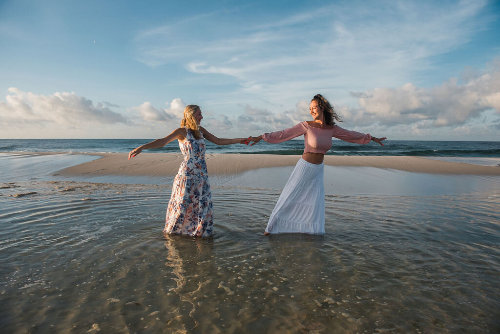 girl twirling girl in ocean-pensacola family photographer