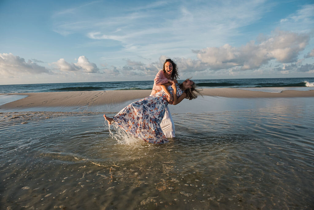 teen dipping teen in water-pensacola family photographer