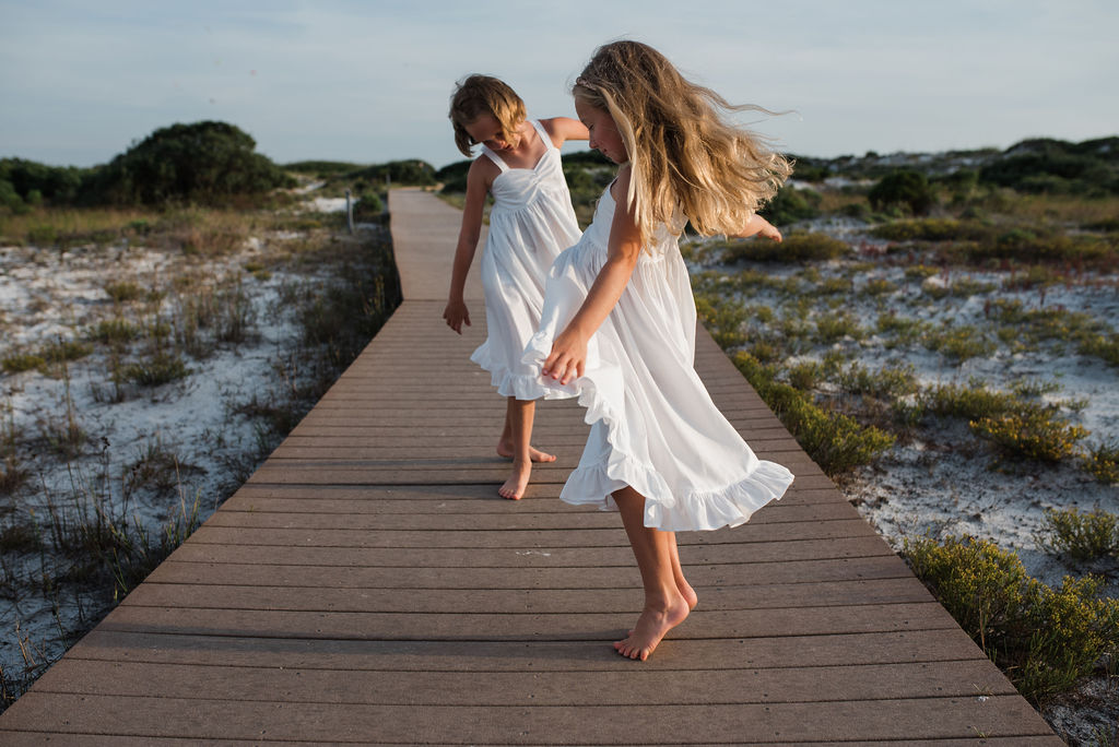 girls dancing on boardwalk-pensacola beach ann mangum photography