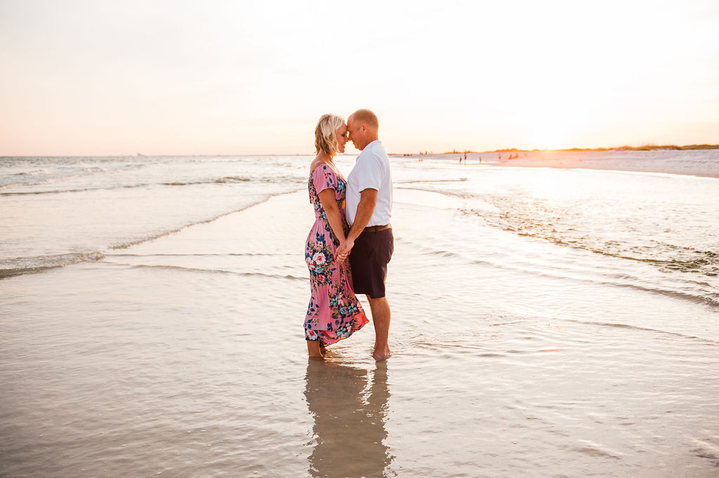 mom and dad at beach hugging-pensacola family photographer