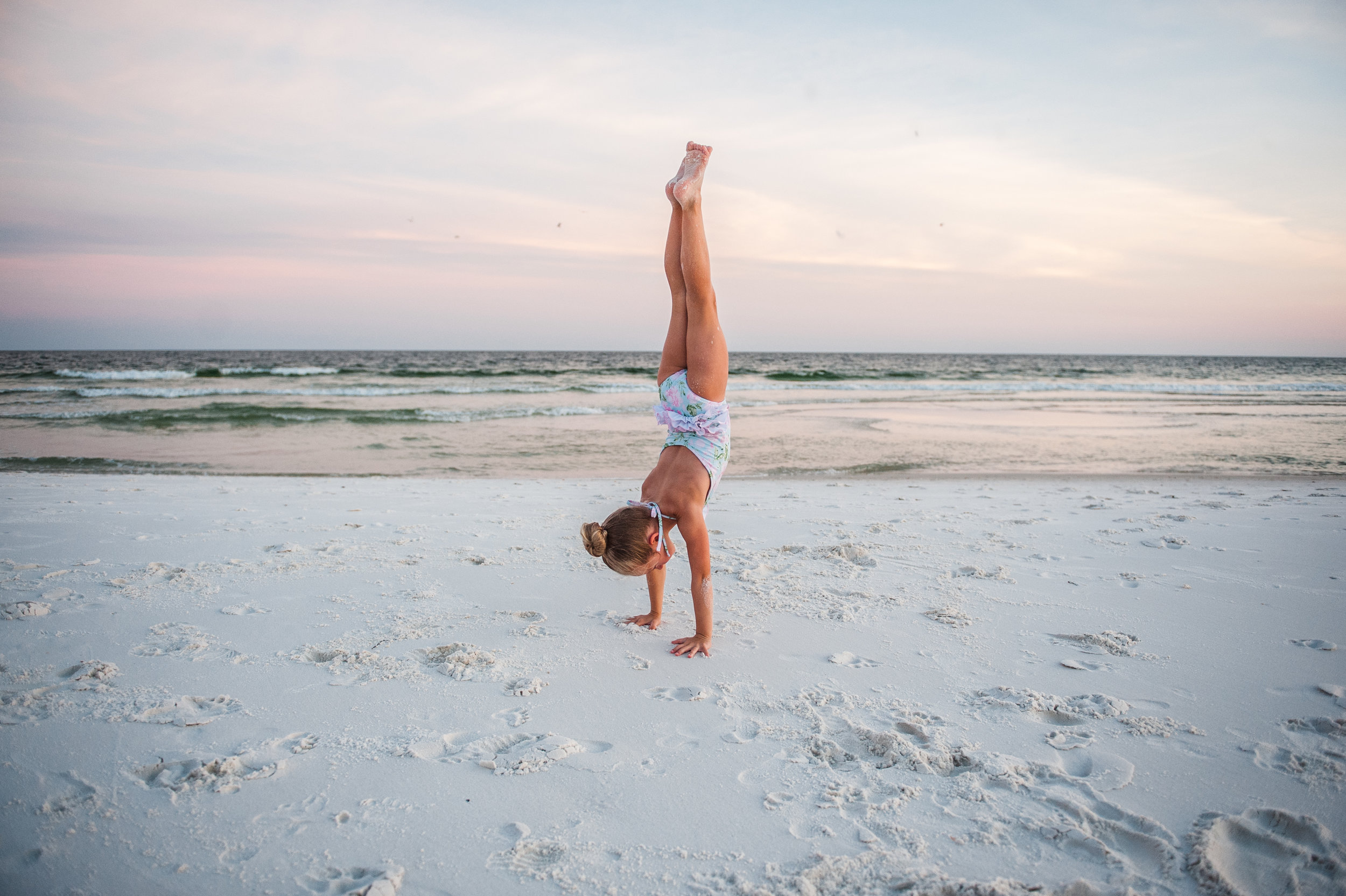 girl doing hand stand in sand-pensacola family photographer-ann mangum photography