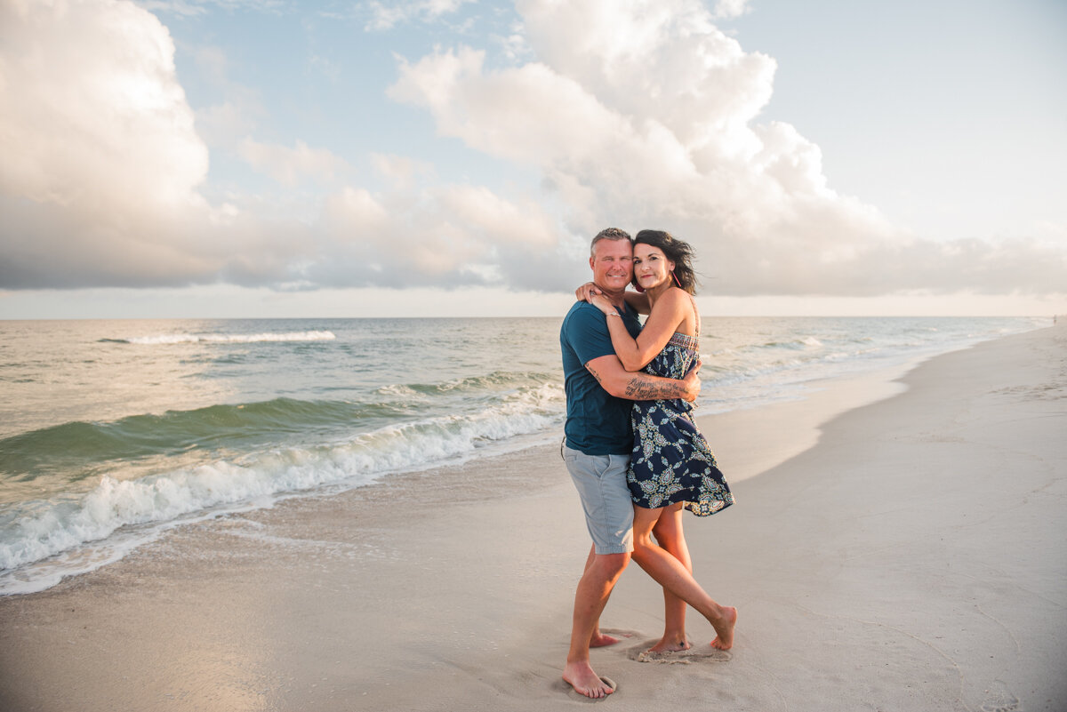 couple under clouds at beach-pensacola family photographer-Ann Mangum Photography