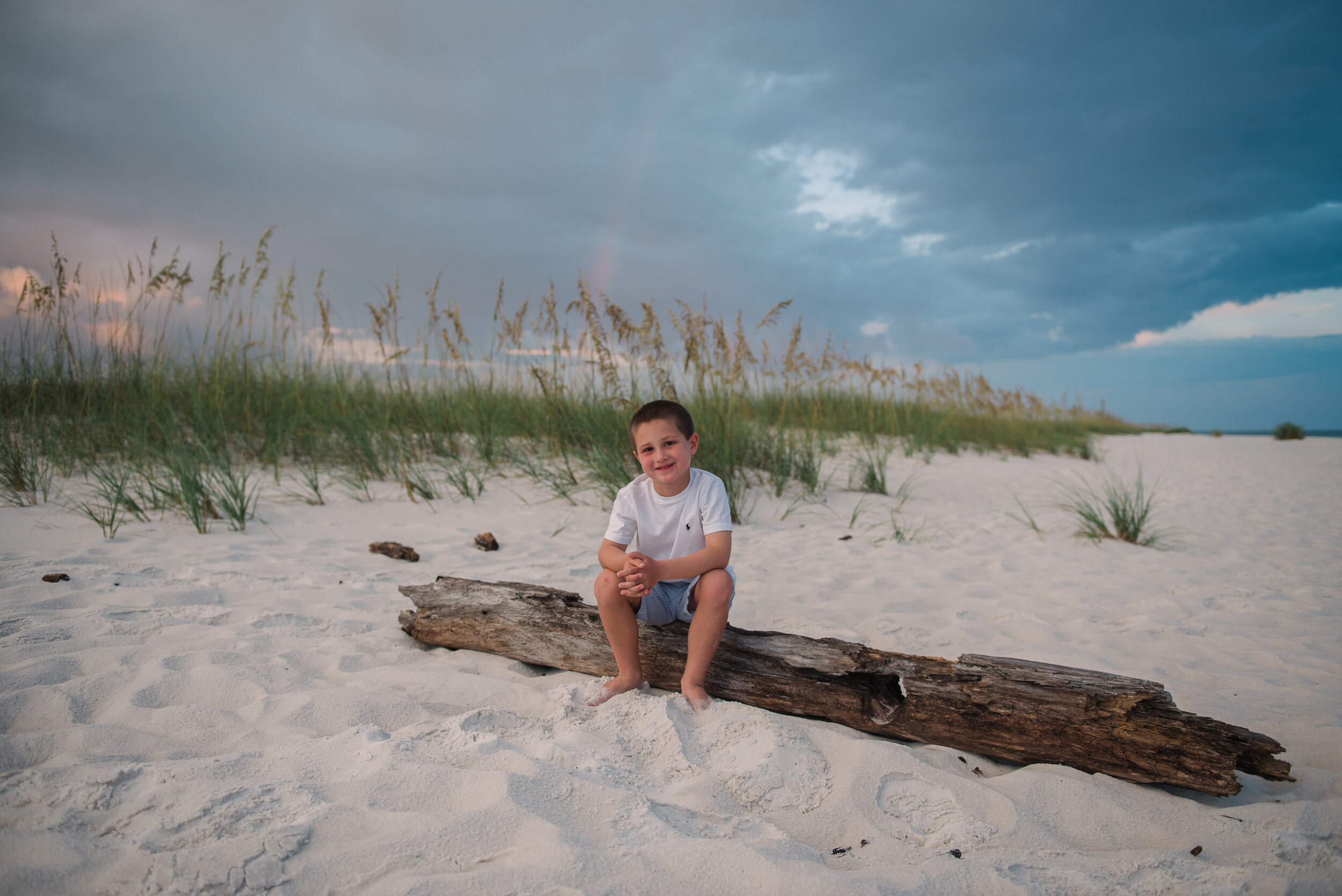boy on log at beach-pensacola family photography-Ann Mangum Photography