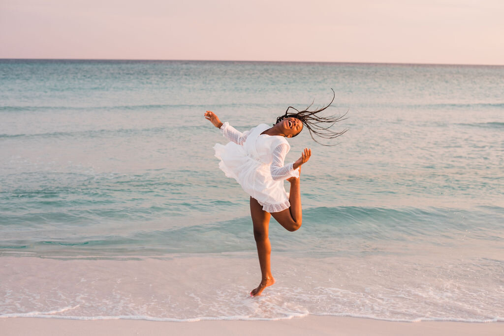 girl jumping in sand-pensacola beach photographer