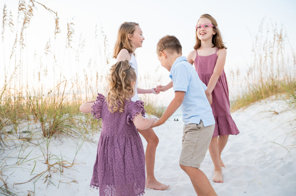 kids in circle laughing at Pensacola Beach