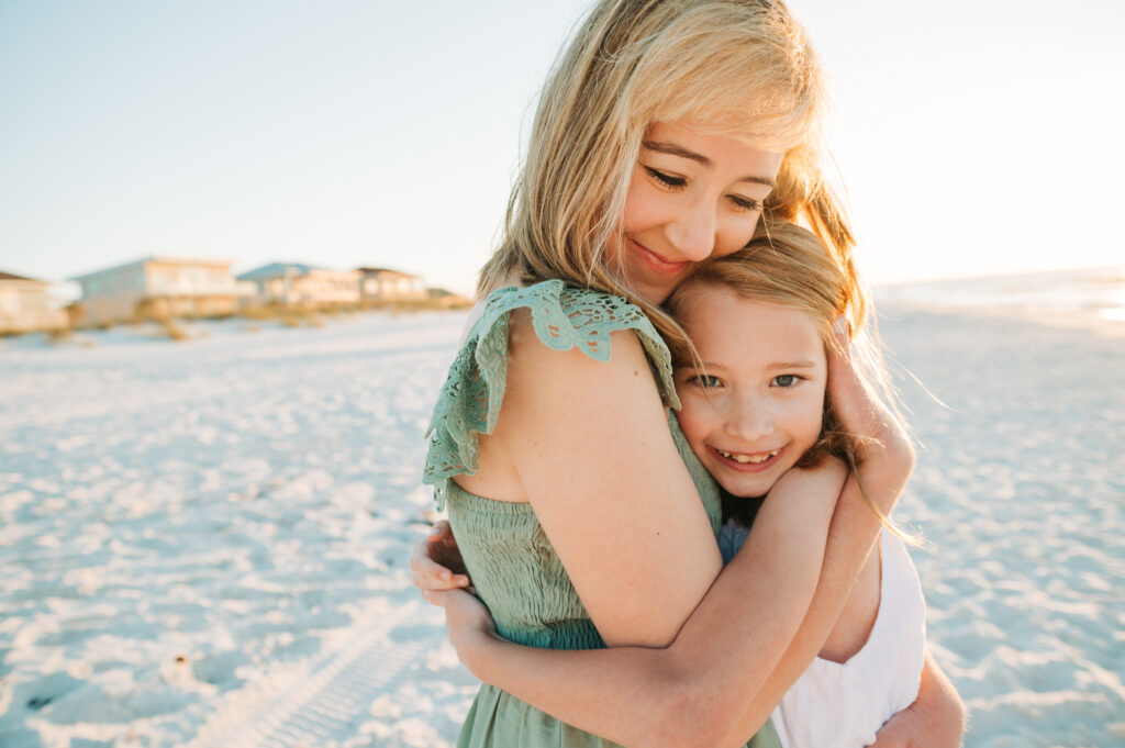 mom hugging daughter at Pensacola Beach