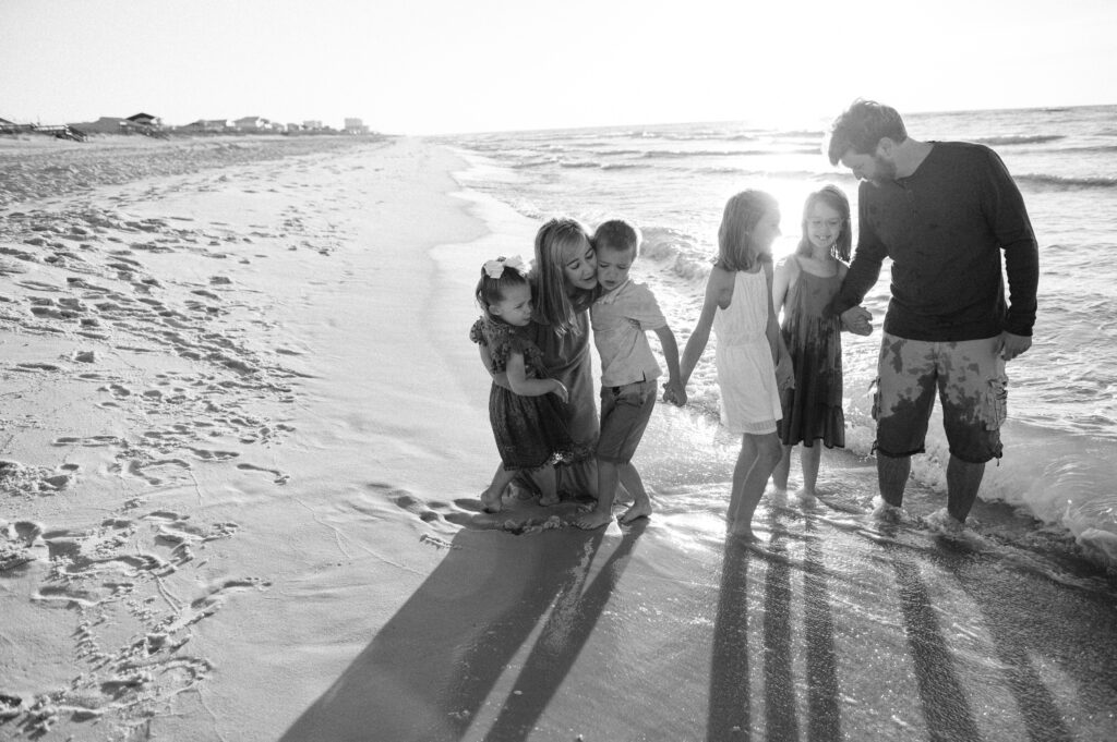 family by ocean playing at Pensacola Beach