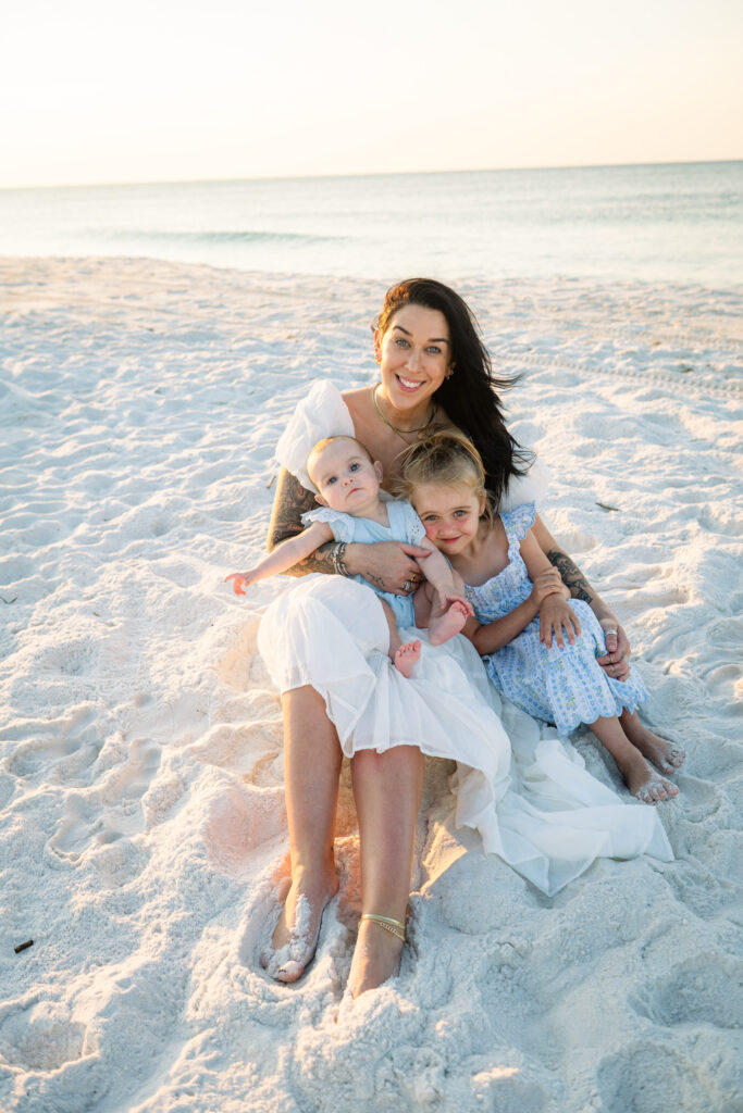 mom with kids sitting at Pensacola Beach