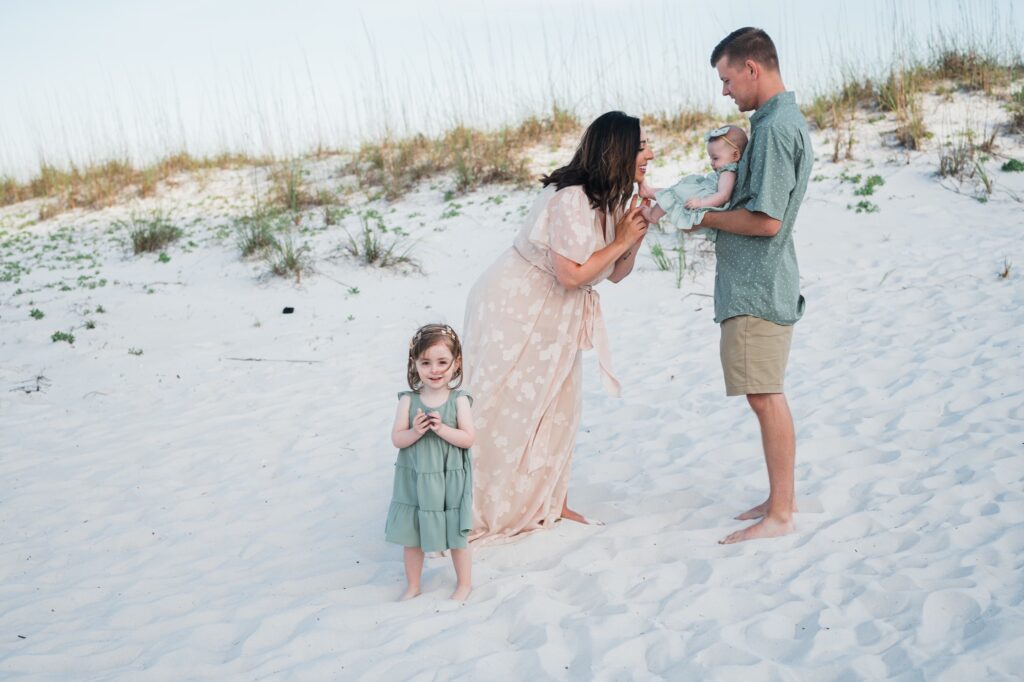mom kissing baby's toes at Penacola Beach