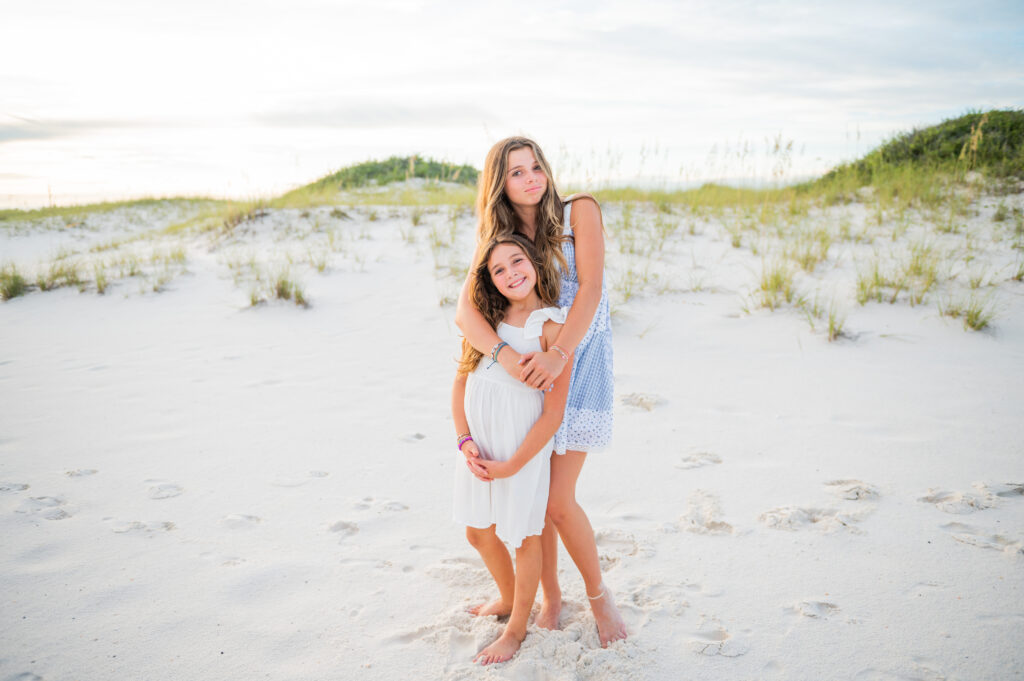 sisters hugging at perdido key beach